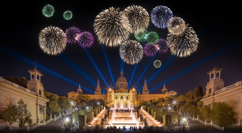The magic fountain in Barcelona, with fireworks going off in the background.