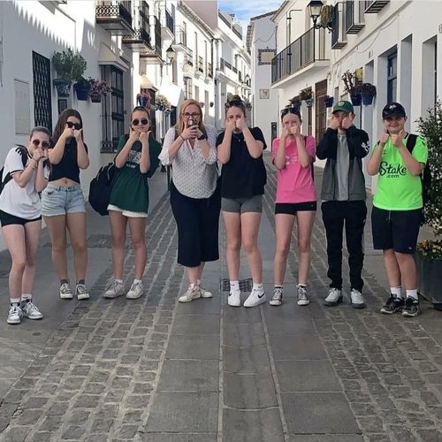 8 students on a recent Spanish language school trip all giving a double thumbs up.
