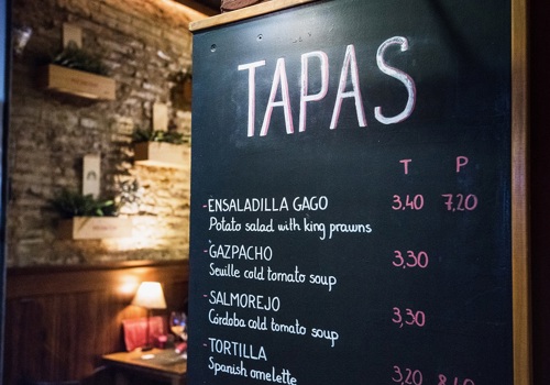 A tapas menu at a restaurant in Spain, offering tasting experiences for students.