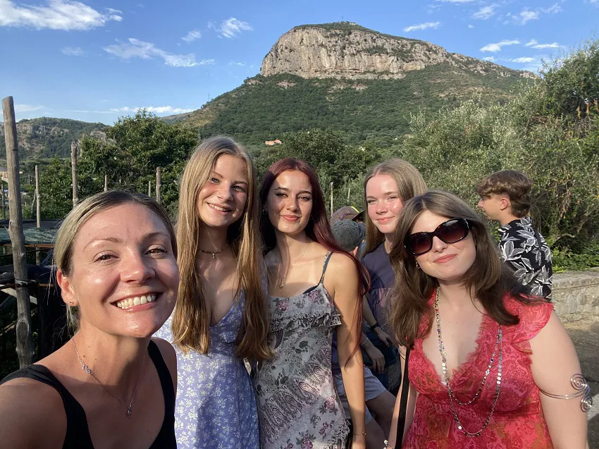Students smiling on a school trip to the Bay of Naples