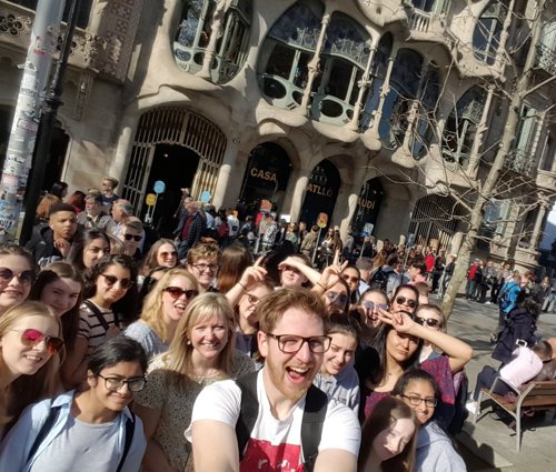 A group from a recent Spanish language school trip posing in front of Casa Batlló, former home of Antoni Gaudi.