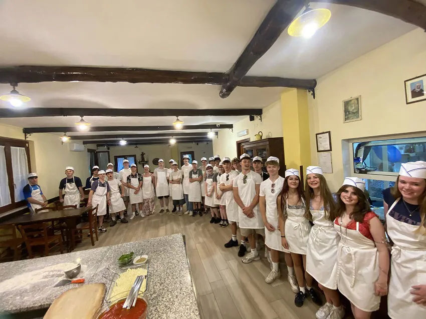 Students at a pasta making working whilst on a Bay of Naples school trip