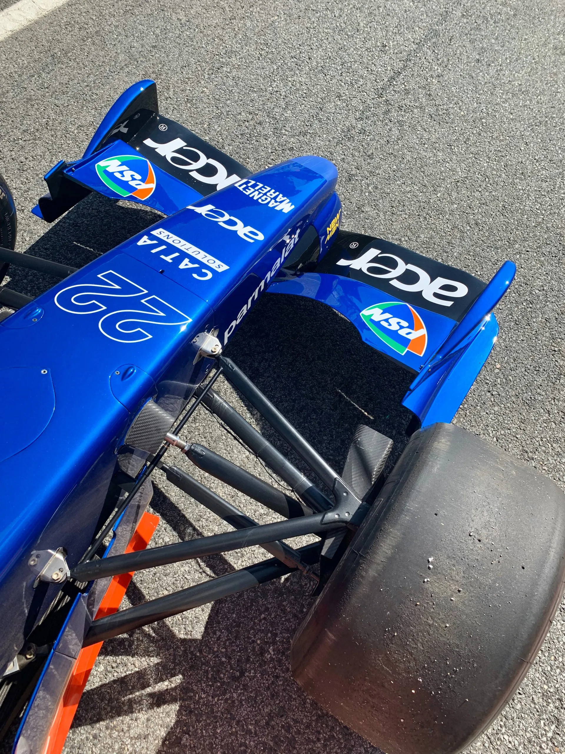 A blue race car on the track at Circuit de Catalunya in Barcelona.